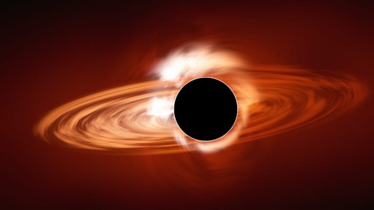 A black hole with a glowing orange accretion disc.