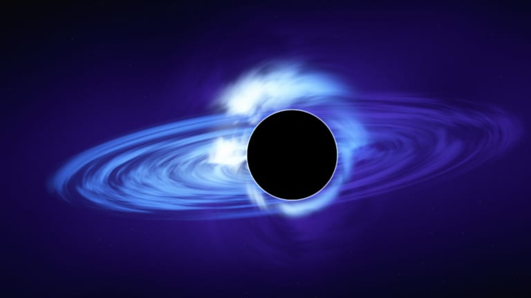 A black hole with a glowing blue accretion disc.