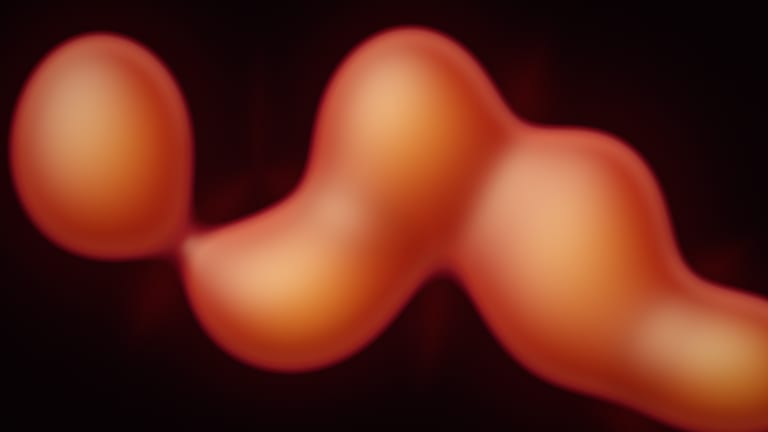 Soft orange lava shapes drifting on a dark red background.
